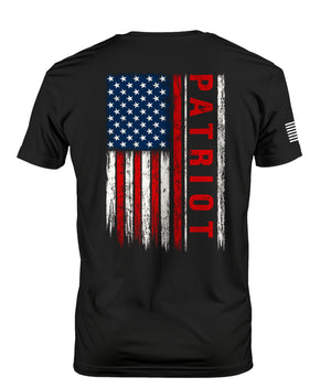 A black short-sleeve t-shirt shown from the back, featuring a distressed vertical American flag graphic with the word 'PATRIOT' printed in red down the right side of the flag. A small white graphic is visible on the left sleeve.