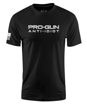 A black short-sleeve crewneck t-shirt with 'PRO-GUN ANTI-IDIOT' printed in white across the chest, featuring a white American flag graphic on the right sleeve.