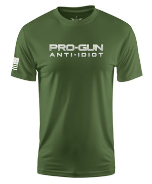 An olive green short-sleeve t-shirt with 'PRO-GUN ANTI-IDIOT' printed in white across the chest and a white American flag graphic on the right sleeve, shown on a plain white background.