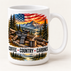 A white ceramic coffee mug featuring a colorful graphic print of a rifle on a log next to a steaming mug, with mountains, pine trees, an American flag, and the text 'COFFEE COUNTRY CARBINES'.