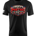 A black short-sleeve t-shirt with a graphic on the chest reading 'I IDENTIFY AS A PISTOL' in red, white, and blue over an American flag and rifle design, plus a small black-and-white flag print on the sleeve.
