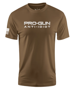 A brown short-sleeve crewneck t-shirt with 'PRO-GUN ANTI-IDIOT' printed in white across the chest and a white American flag graphic on the right sleeve, shown on a plain white background.